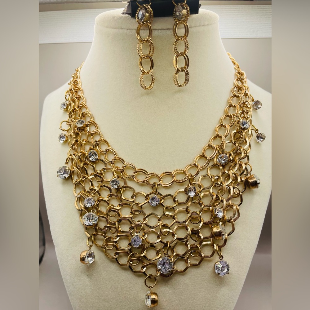 Gold tone chain link bib necklace with clear rhinestones and chain earrings